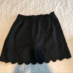 Black linen mini skirt with scallop edge.